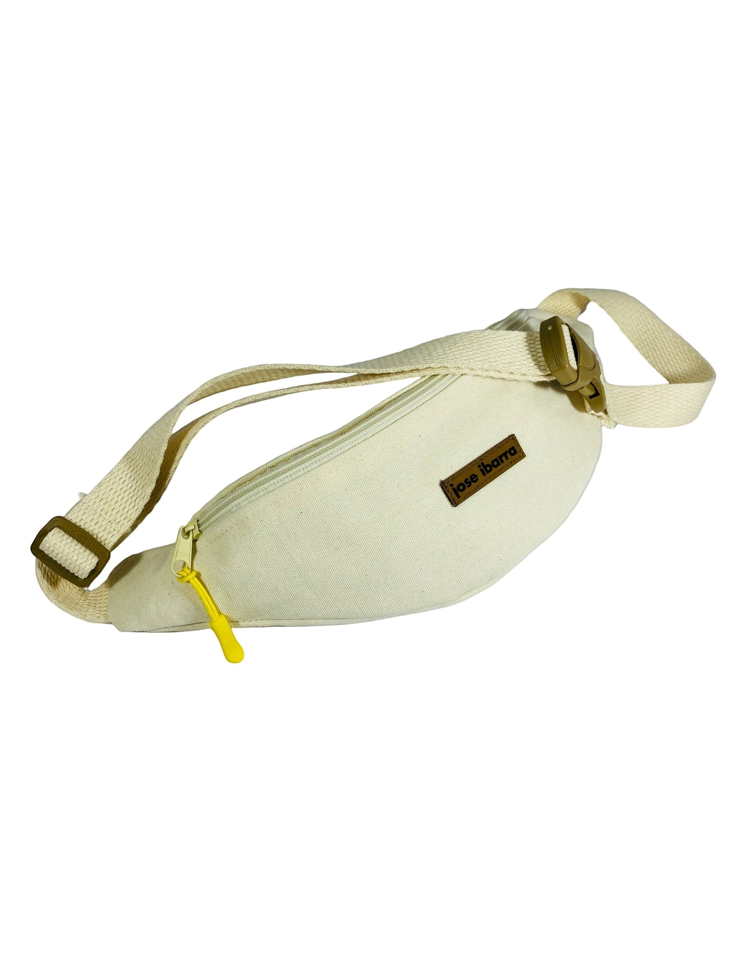 Jose Ibarra Estudio cream canvas fanny pack with yellow zipper and adjustable strap. Hand-painted design.