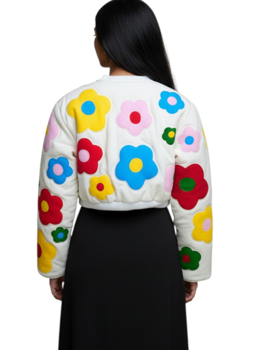 Jose Ibarra Estudio white quilted jacket with colorful hand-painted floral appliques, long sleeves, and cropped fit.