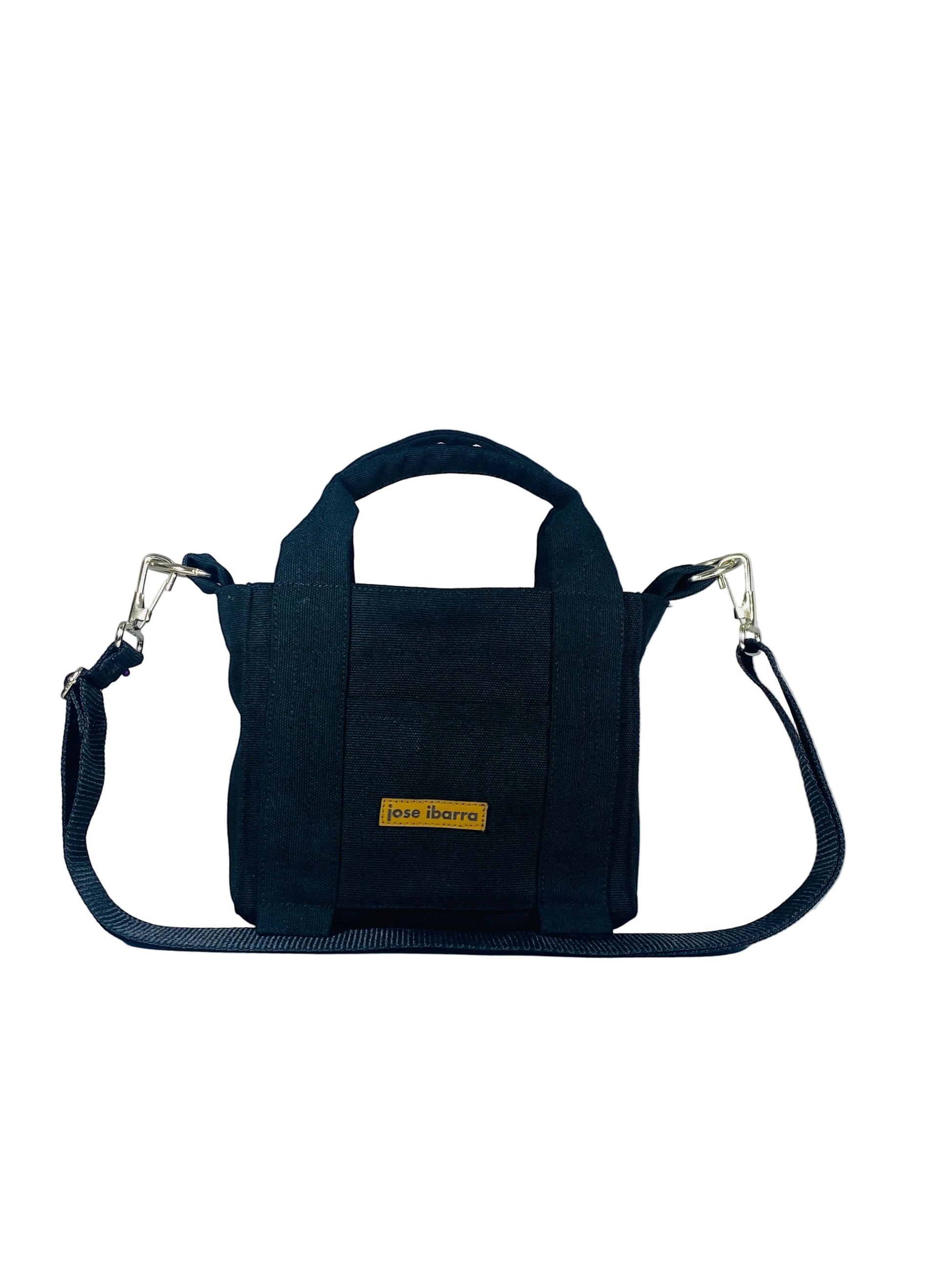 Jose Ibarra black canvas mini tote bag with hand-painted details and adjustable strap.
