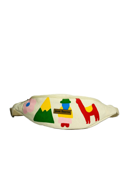 Jose Ibarra cream canvas fanny pack with hand-painted folk art designs including mountains, a person, and a llama.