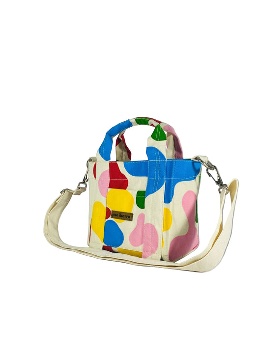 Jose Ibarra small canvas tote bag with colorful abstract hand-painted design and adjustable strap.
