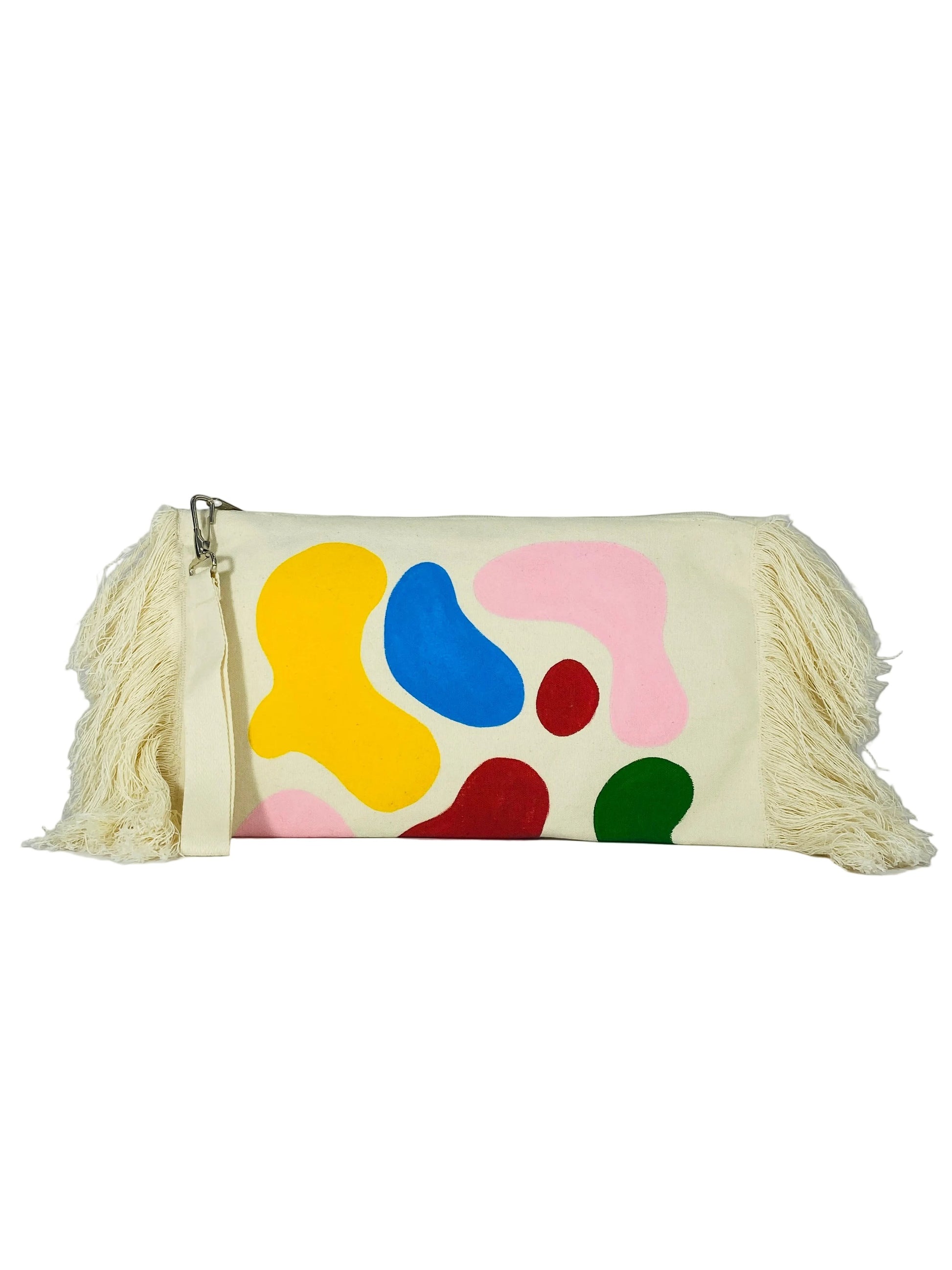 Jose Ibarra Estudio cream cotton clutch with hand-painted abstract colourful shapes and fringe detail. Includes wrist strap.