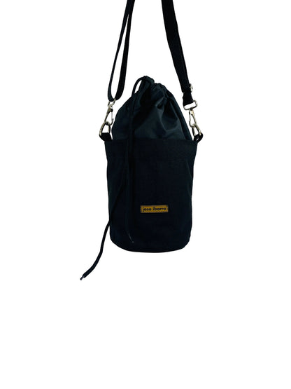 Jose Ibarra Estudio black cotton canvas bucket bag with drawstring closure and internal pocket. Hand-painted art details.