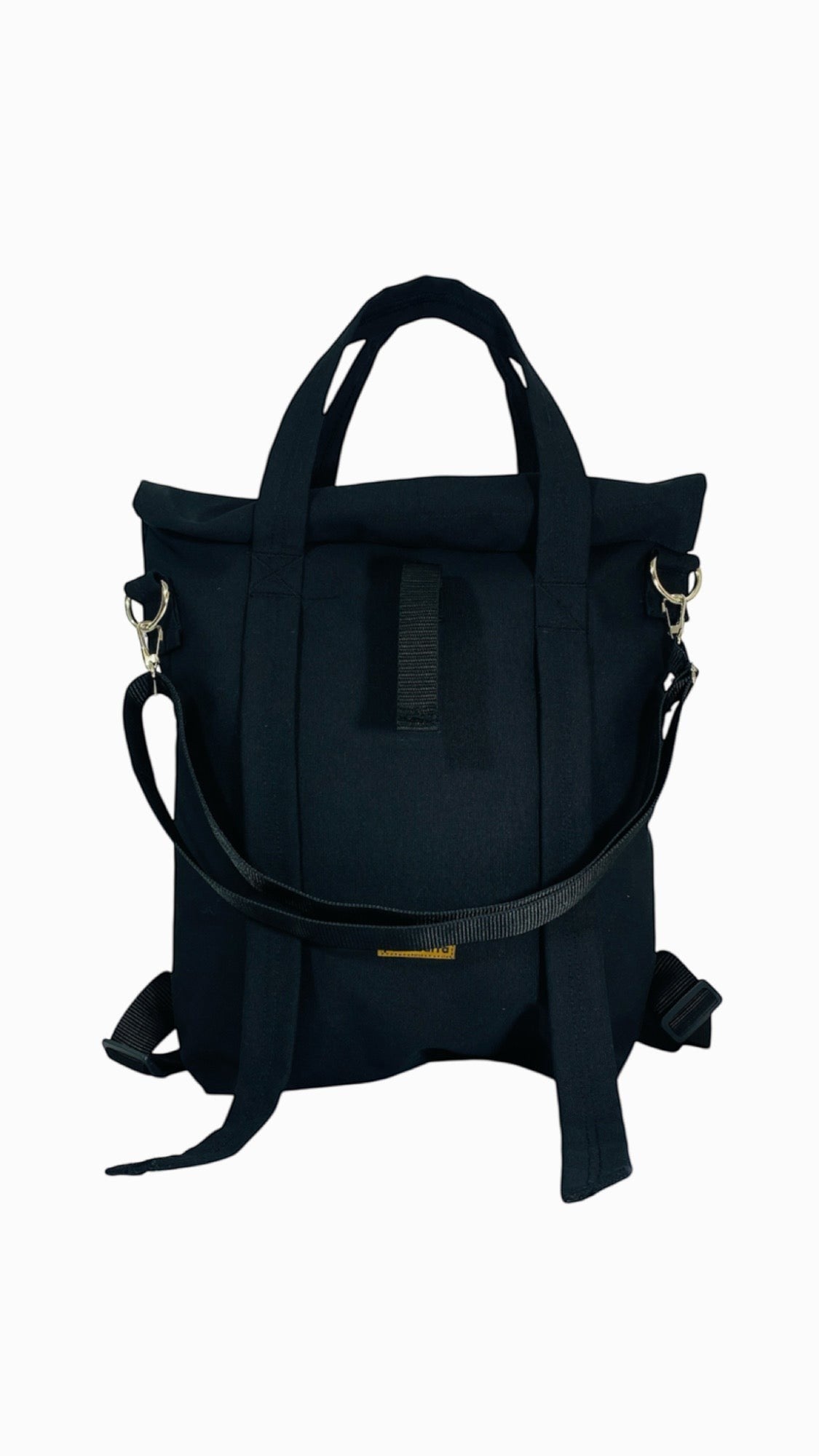 Jose Ibarra Estudio black cotton canvas multi-use bag, convertible to backpack, tote, or crossbody. Hand-painted design.