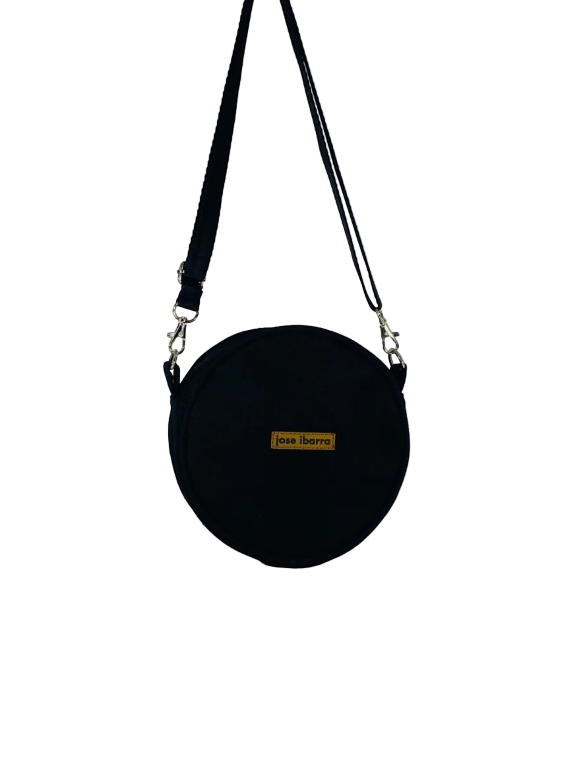 Jose Ibarra Studio black canvas round crossbody bag with adjustable strap and internal lining. 18cm diameter.
