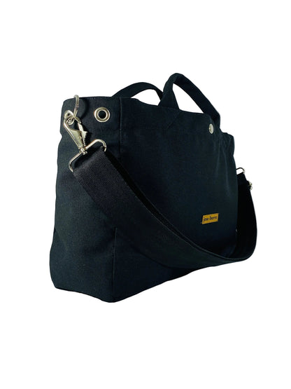 Jose Ibarra Estudio black canvas medium tote bag with adjustable strap and silver hardware.