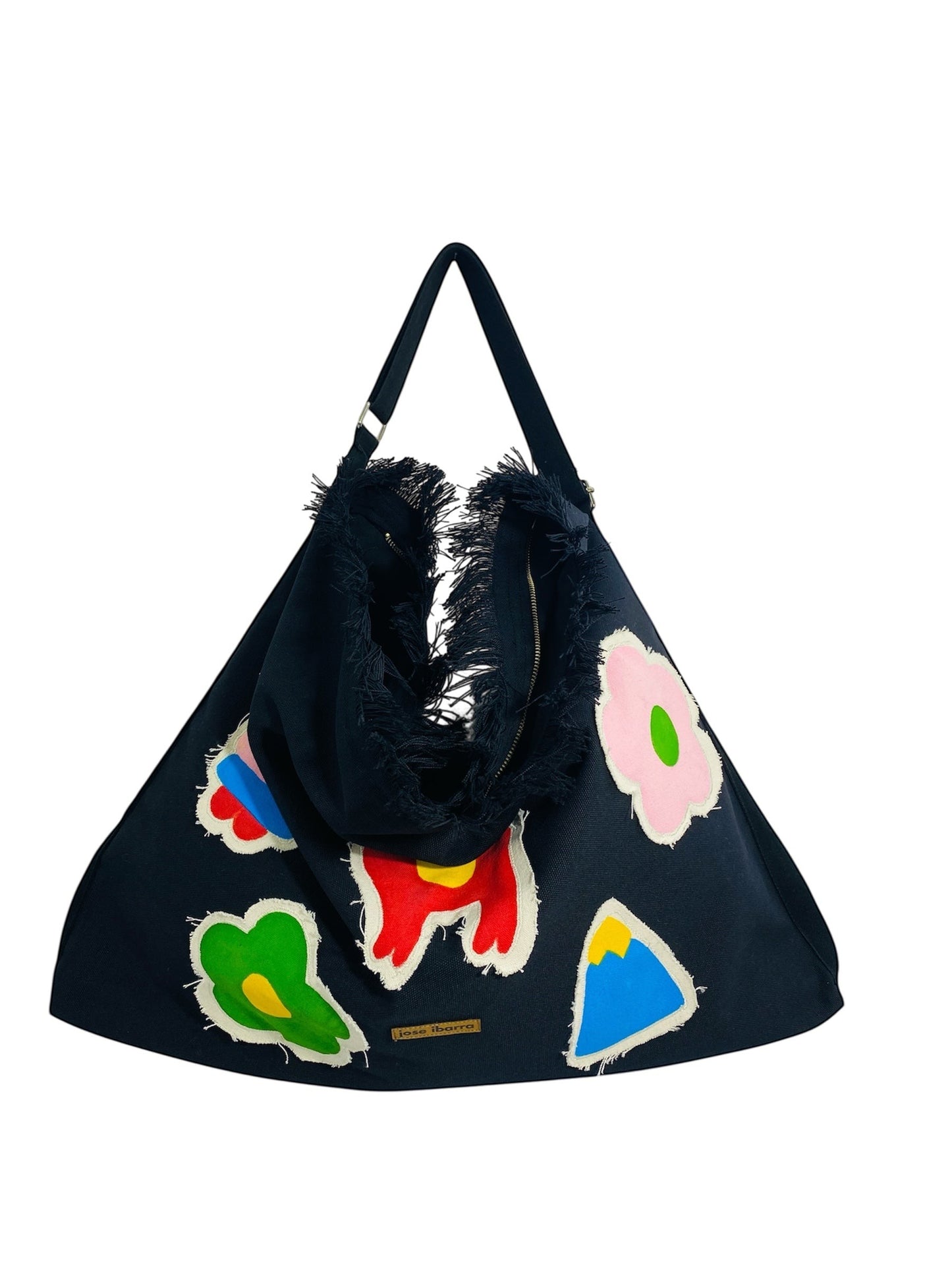 Jose Ibarra Estudio black cotton canvas tote bag with hand-painted colorful appliques and frayed edges.