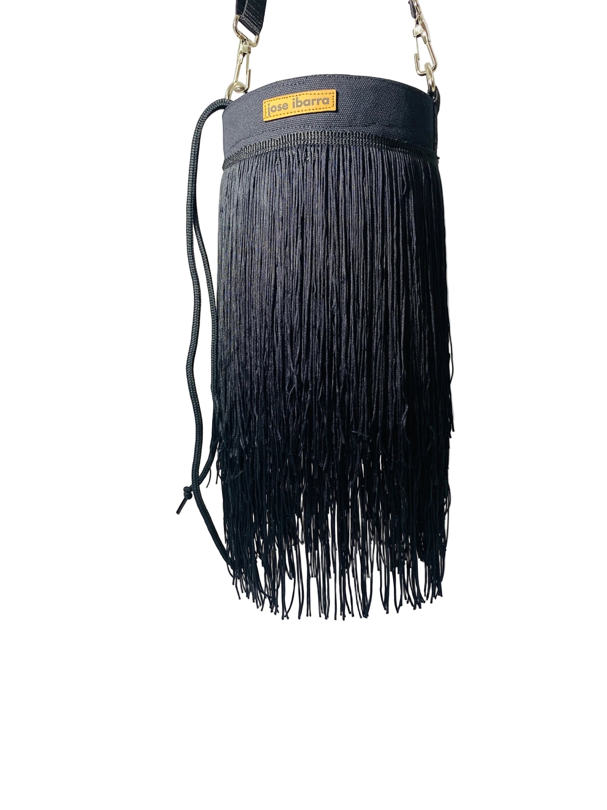 Jose Ibarra Estudio black cotton bucket bag with long fringe detail and adjustable strap.