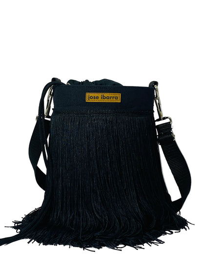 Jose Ibarra Estudio black cotton bucket bag with hand-painted art and traditional fringe detail. Adjustable strap.