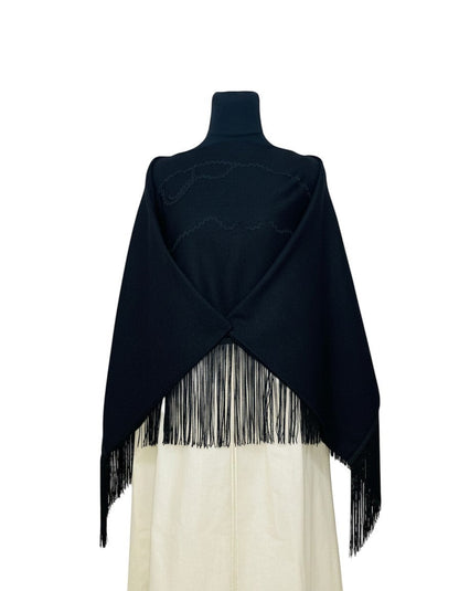 Jose Ibarra Estudio black wool shawl with fringe and zigzag trim, inspired by Ecuadorian volcanoes.