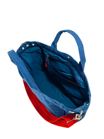 Jose Ibarra Estudio blue canvas tote bag with red strap and interior pockets. Includes detachable strap.