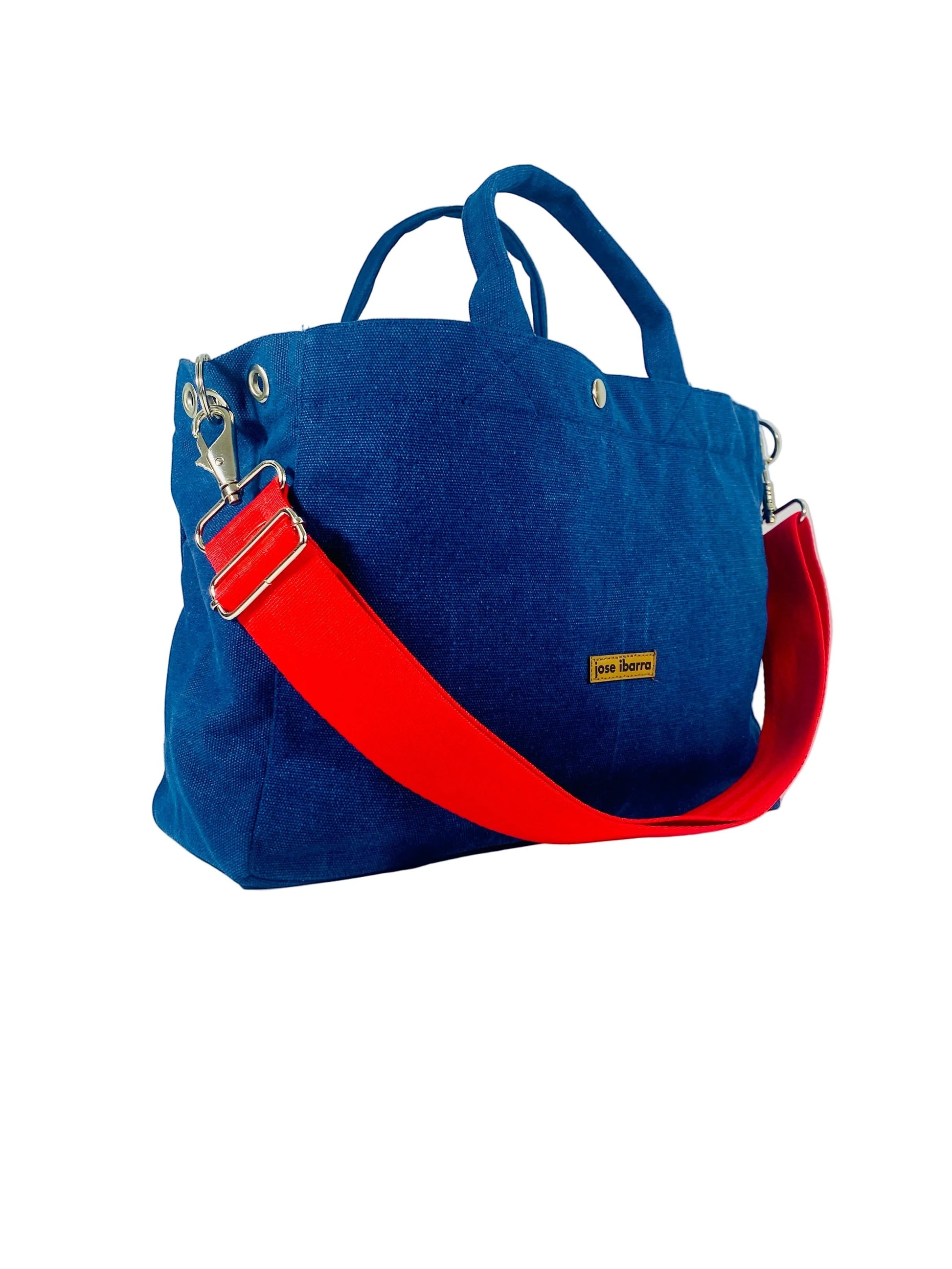 Jose Ibarra Estudio medium blue canvas tote bag with red strap, internal pockets, and detachable strap.