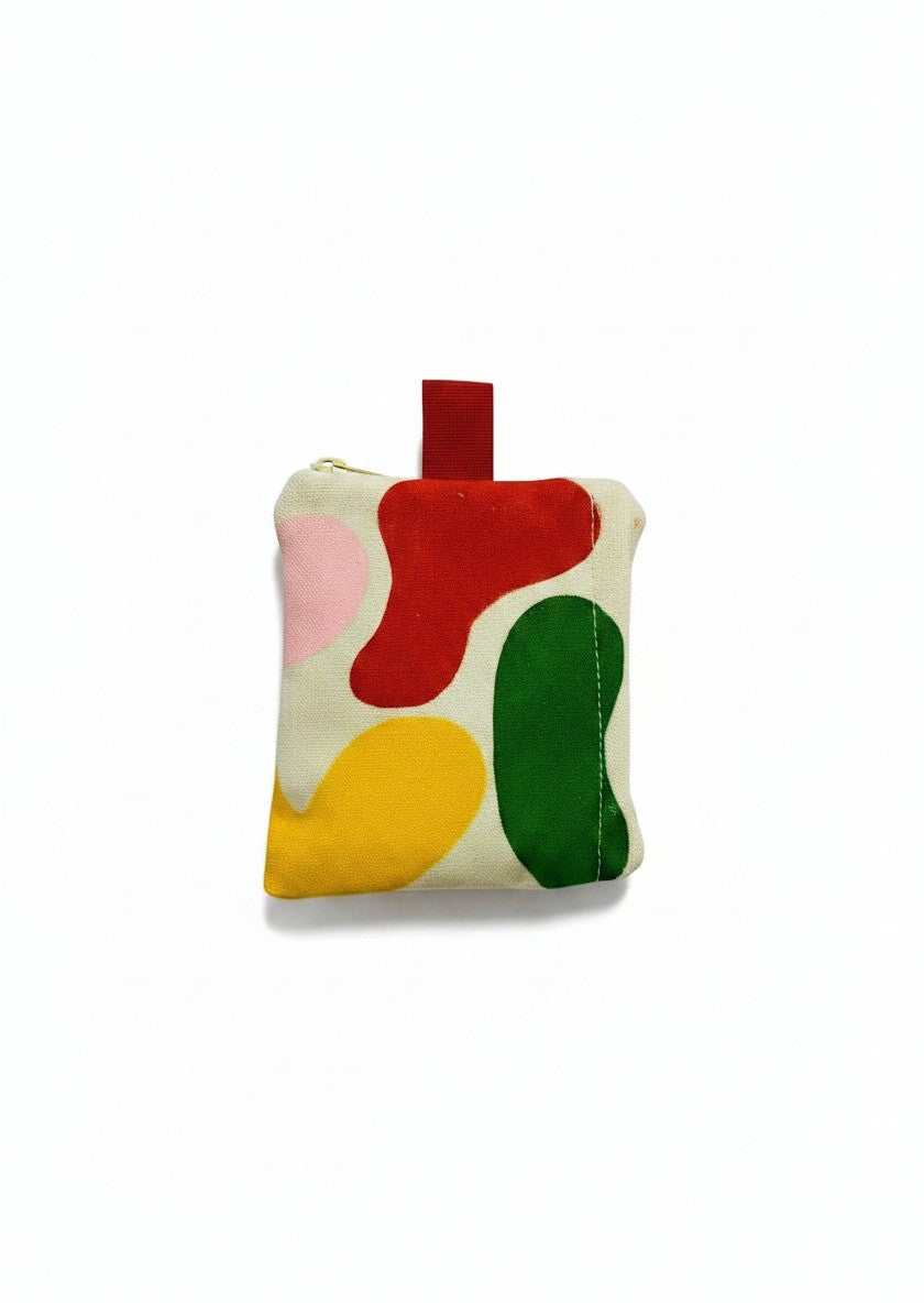 Jose Ibarra Estudio cream canvas coin purse with hand-painted abstract red, yellow, green, and pink shapes. Zipper closure.