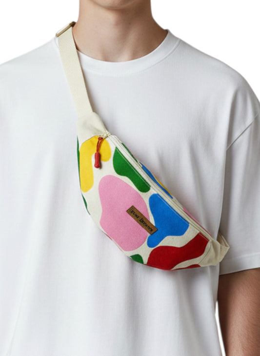 Jose Ibarra Estudio cream canvas fanny pack with abstract colorful shapes in red, blue, yellow, green, and pink. Hand-painted design.