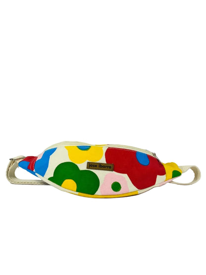 Jose Ibarra Estudio cream canvas fanny pack with hand-painted abstract floral design in red, yellow, green, and blue.