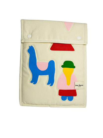 Jose Ibarra Estudio cream canvas iPad sleeve with hand-painted llama and figure applique. Features snap closure.