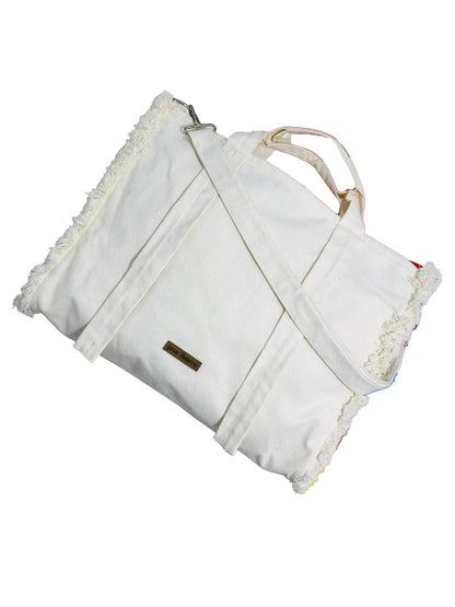 Jose Ibarra Estudio off-white cotton canvas tote bag with hand-painted details and frayed edges. Includes strap.