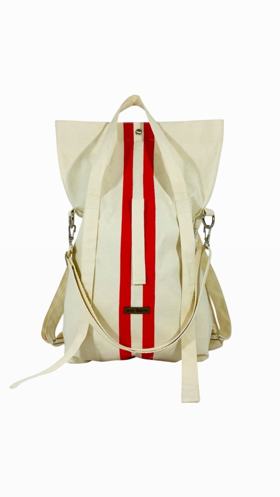 Jose Ibarra Estudio cream canvas tote bag with red vertical stripes, convertible to backpack or crossbody.