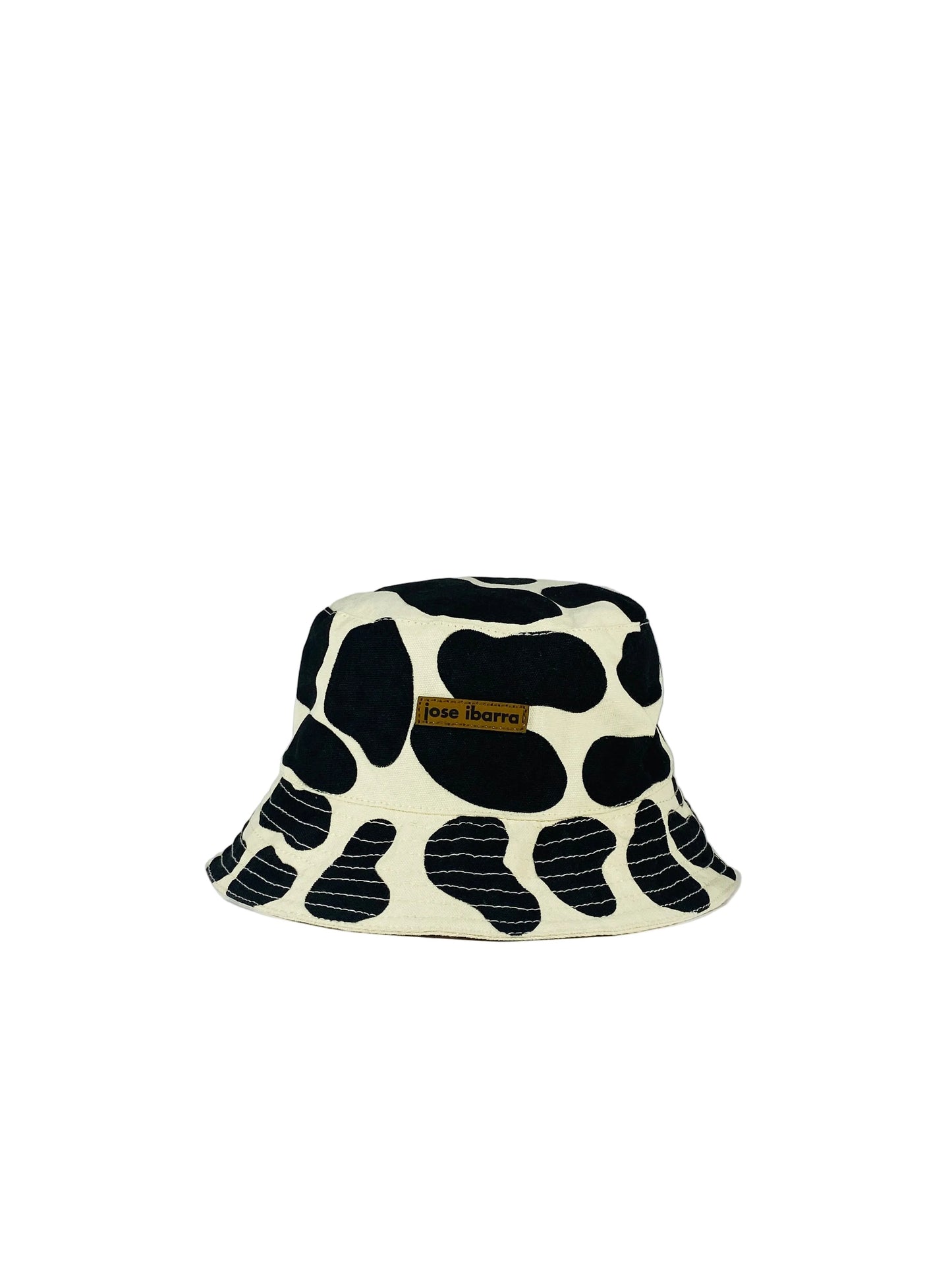 Jose Ibarra Studio black and cream cow print bucket hat. Thick cotton canvas, hand-painted design, cotton lining.