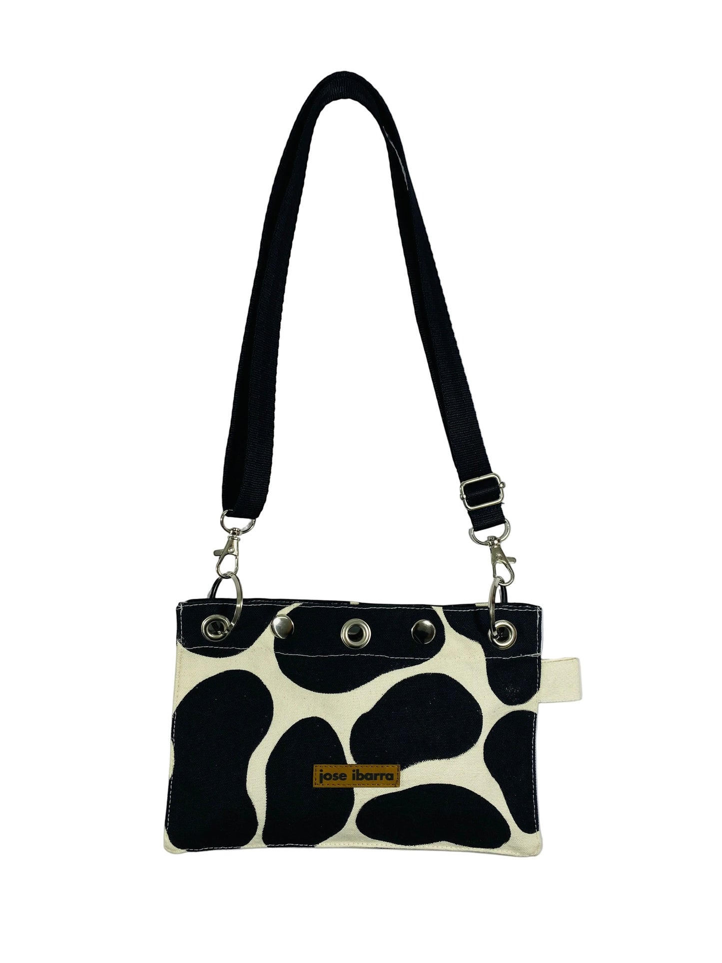 Jose Ibarra Estudio black and white cow print canvas pouch with adjustable strap and internal lining. 23x17 cm.