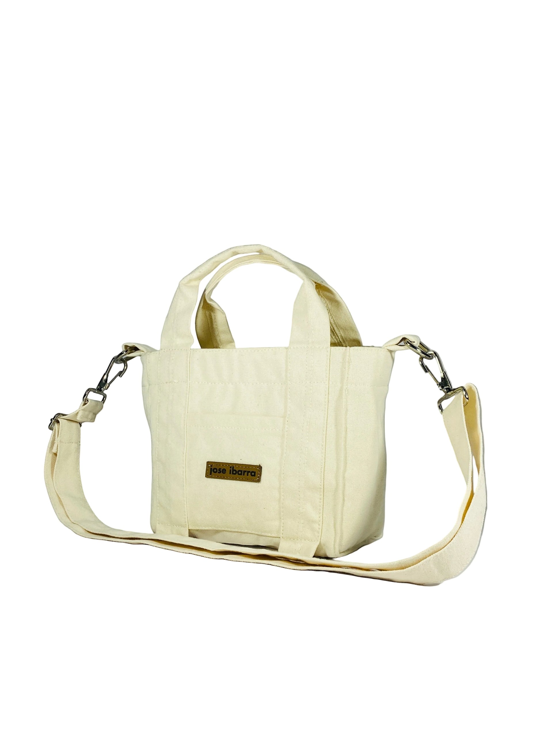 Jose Ibarra Estudio cream canvas tote bag, hand-painted, with internal pockets and strap. 18x16x9 cm.