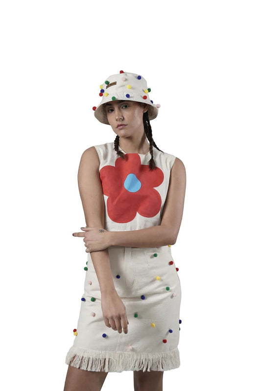 Jose Ibarra Estudio cream 100% cotton canvas dress with hand-painted red flower and pom-pom details. Fringed hem.
