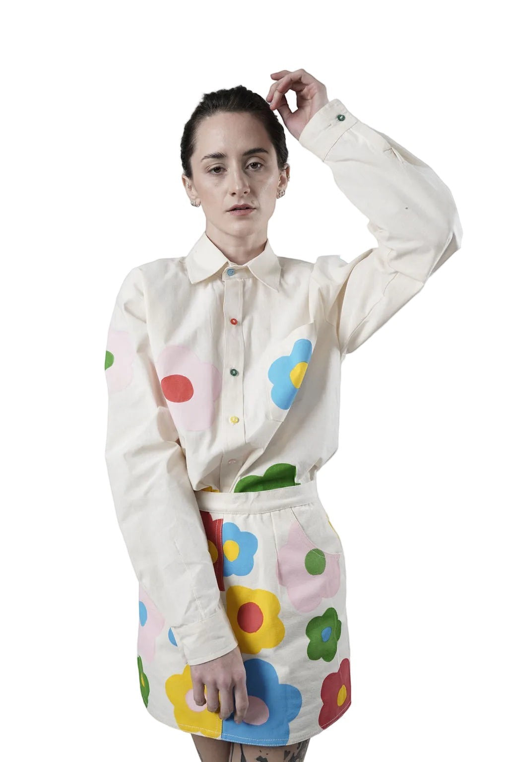 Jose Ibarra Estudio cream 100% cotton loose-fit shirt with hand-painted colourful flowers and contrasting buttons.