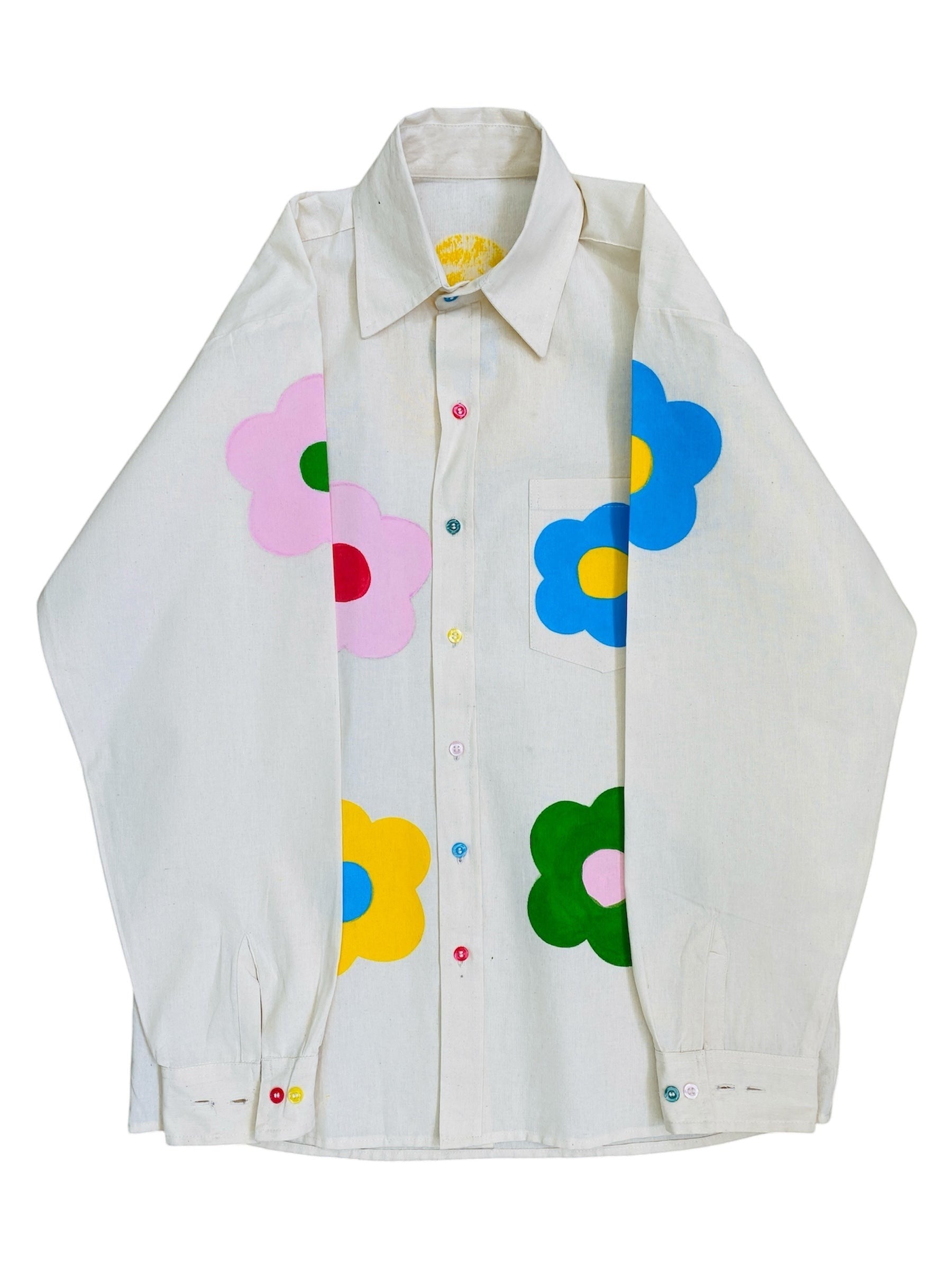 Jose Ibarra Estudio cream 100% cotton oversized shirt with hand-painted colorful flowers and multicolor buttons.