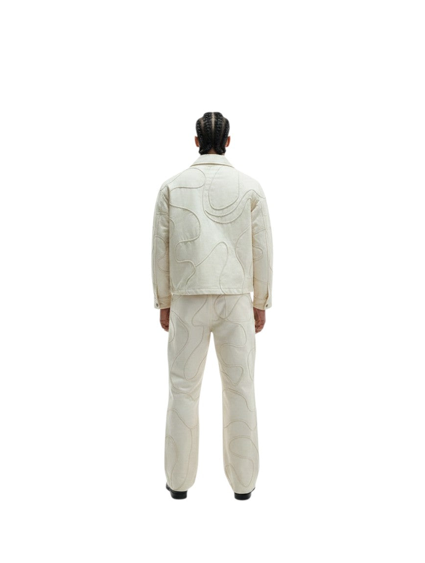 Jose Ibarra Estudio cream 100% cotton canvas jacket with hand-painted abstract pattern and matching trousers, worn by a male model.