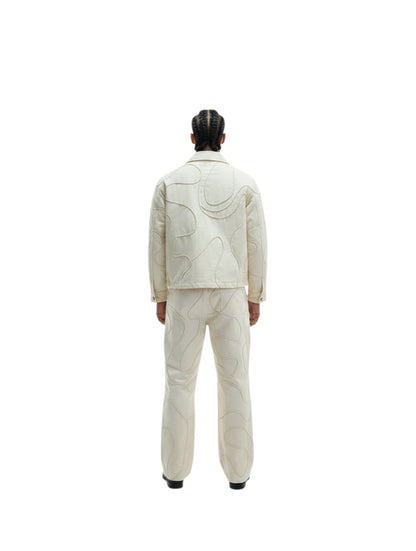 Jose Ibarra Estudio cream 100% cotton canvas jacket with hand-painted abstract pattern and matching trousers, worn by a male model.