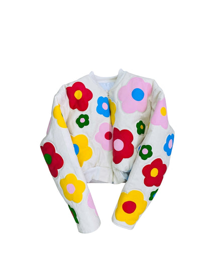 Jose Ibarra Estudio cream cotton jacket with colorful hand-painted floral appliques, cropped bomber style.