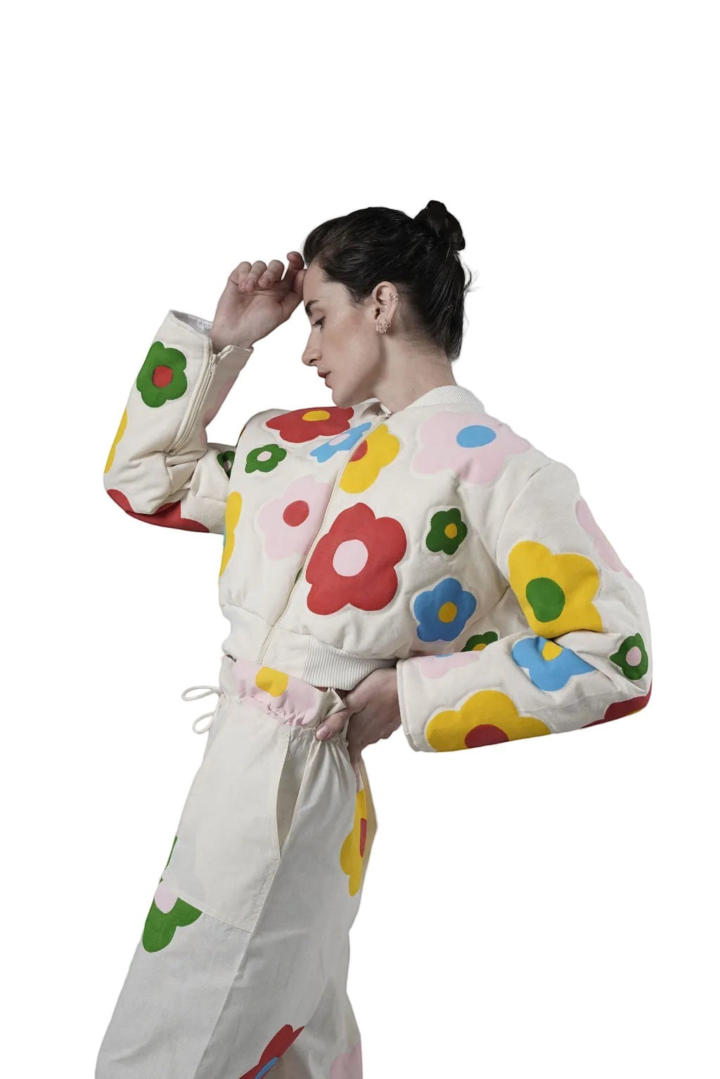 Jose Ibarra Estudio cream cotton bomber jacket with colorful hand-painted floral appliques. Model wears size S.