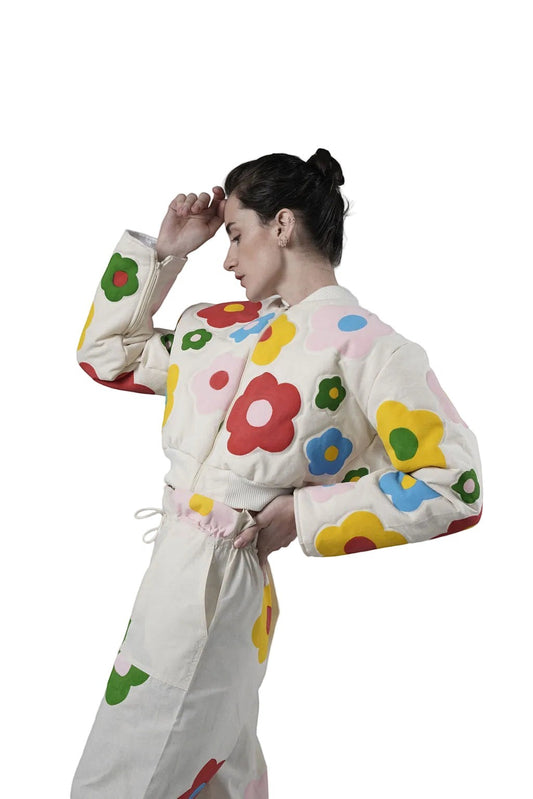 Jose Ibarra Estudio cream cotton bomber jacket with colorful hand-painted floral appliques. Model wears size S.