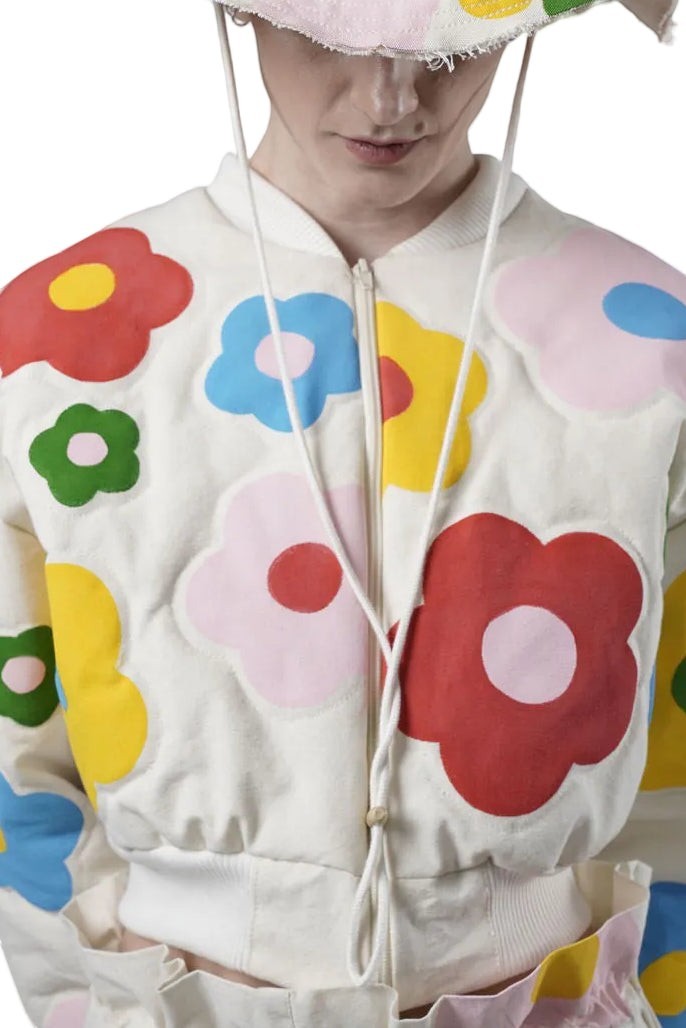 Jose Ibarra Estudio cream cotton bomber jacket with colourful hand-painted flower appliques and ribbed cuffs.