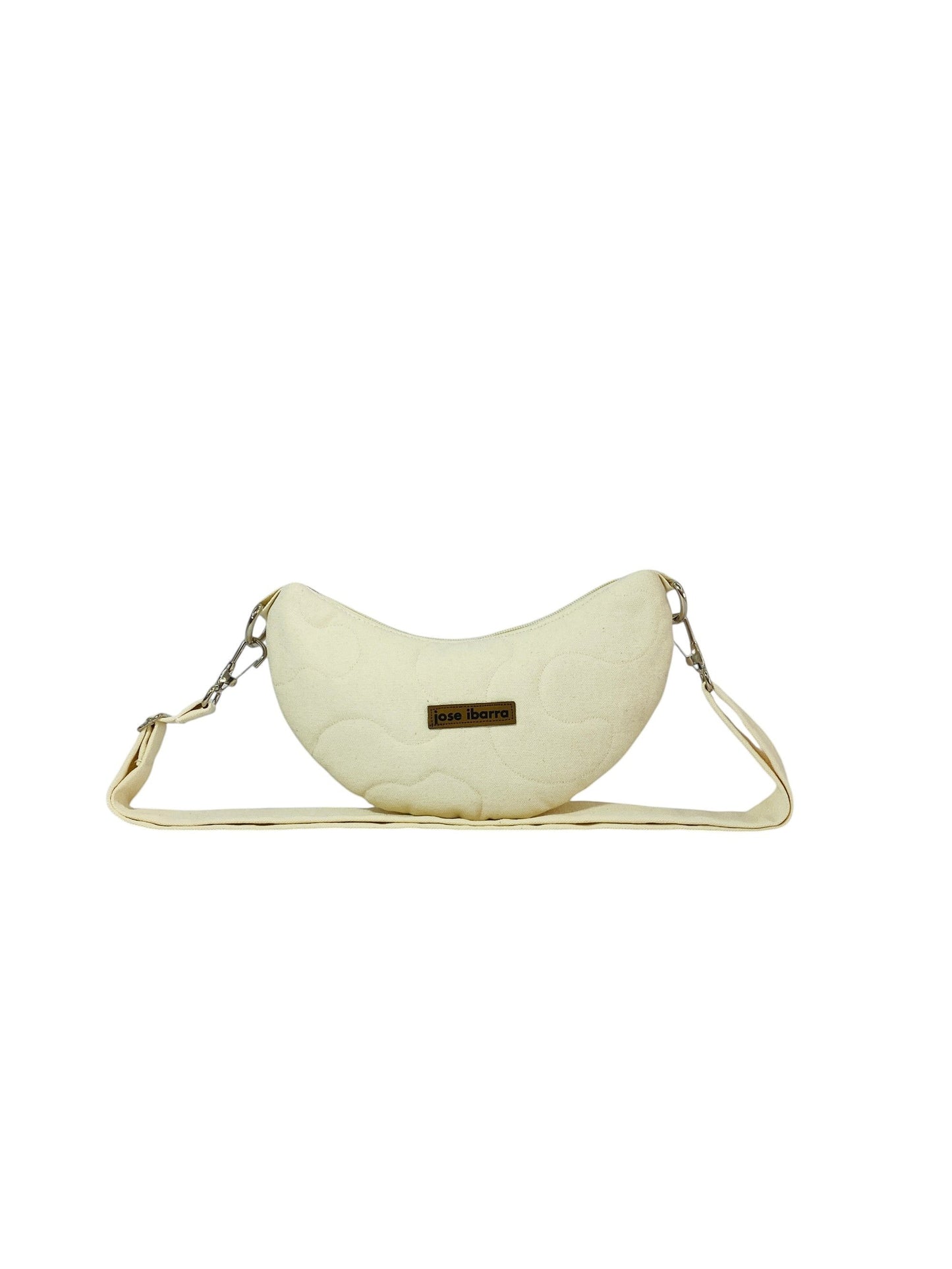 Jose Ibarra Estudio cream quilted cotton Luna bag with hand-painted details and adjustable strap.