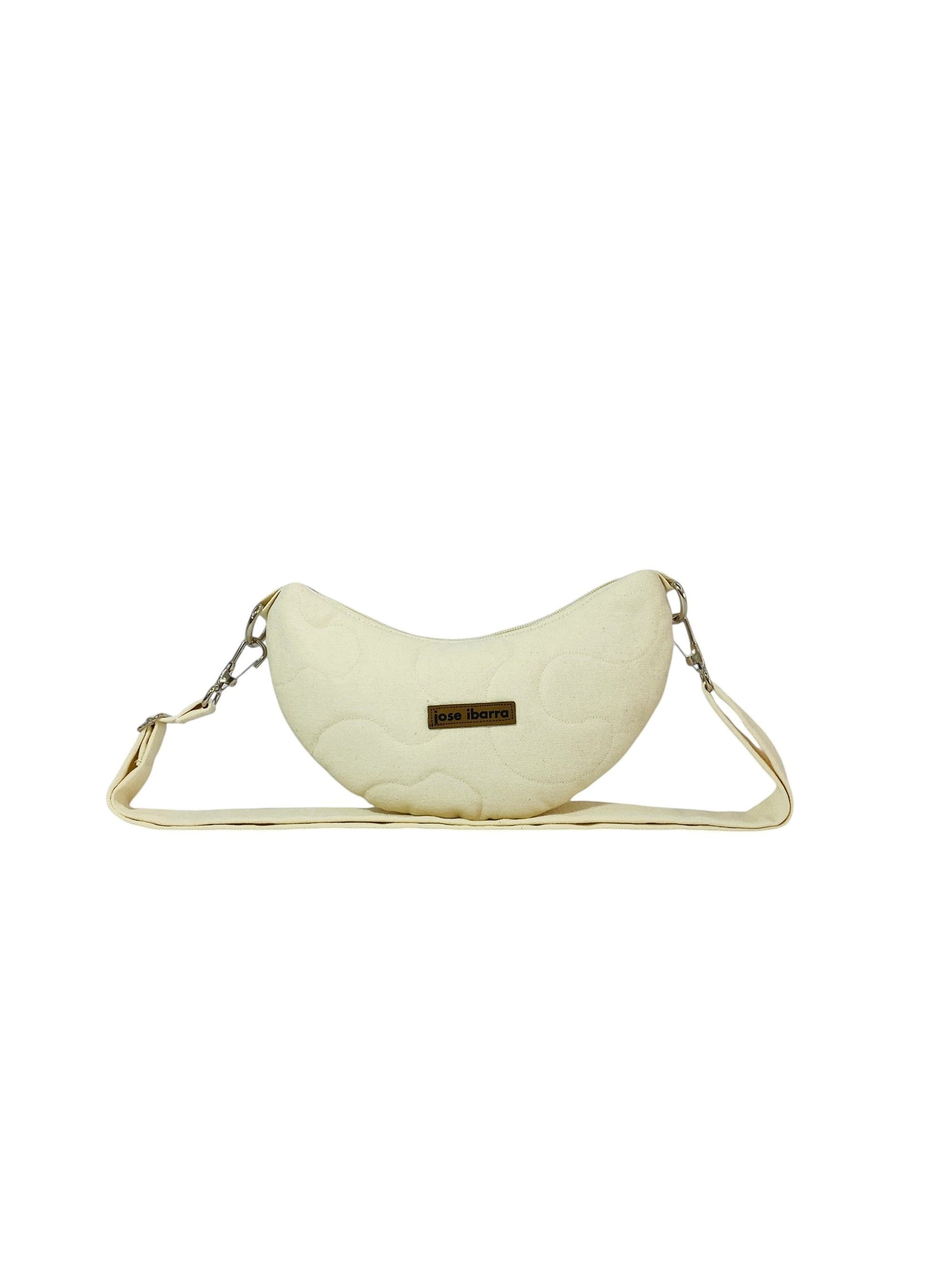 Jose Ibarra Estudio cream quilted cotton Luna bag with hand-painted details and adjustable strap.