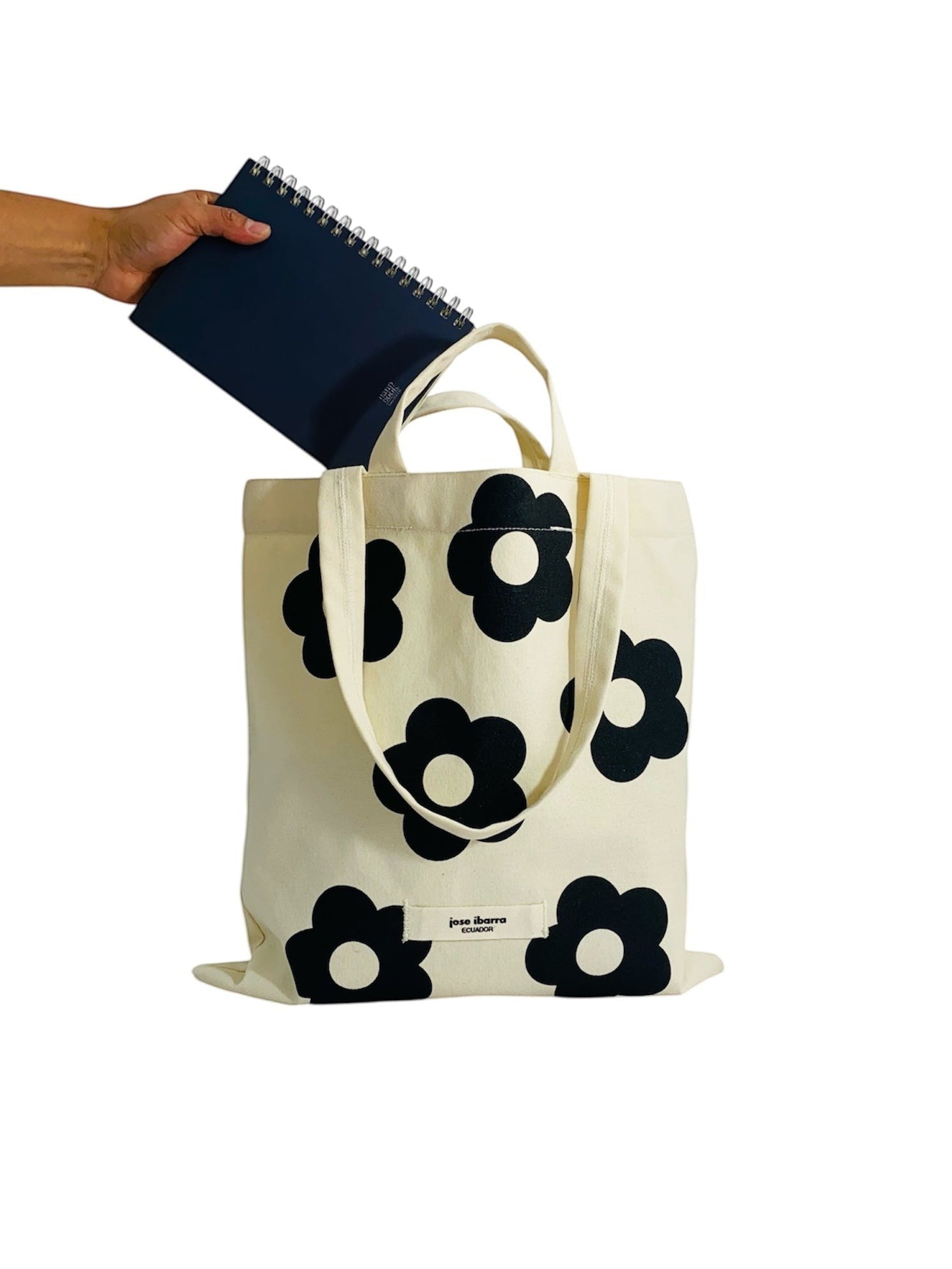 Jose Ibarra Estudio cream canvas tote bag with black floral print and internal pocket. Hand-painted design.
