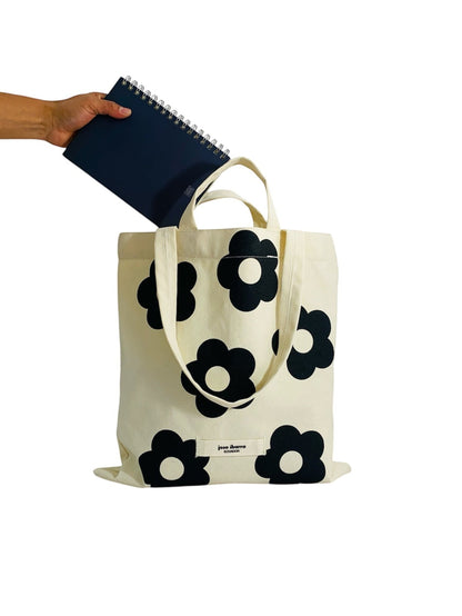 Jose Ibarra Estudio cream canvas tote bag with black floral print and internal pocket. Hand-painted design.