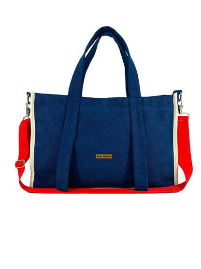 Jose Ibarra Estudio DUA tote bag in navy blue canvas with red straps and cream trim, includes shoulder strap.