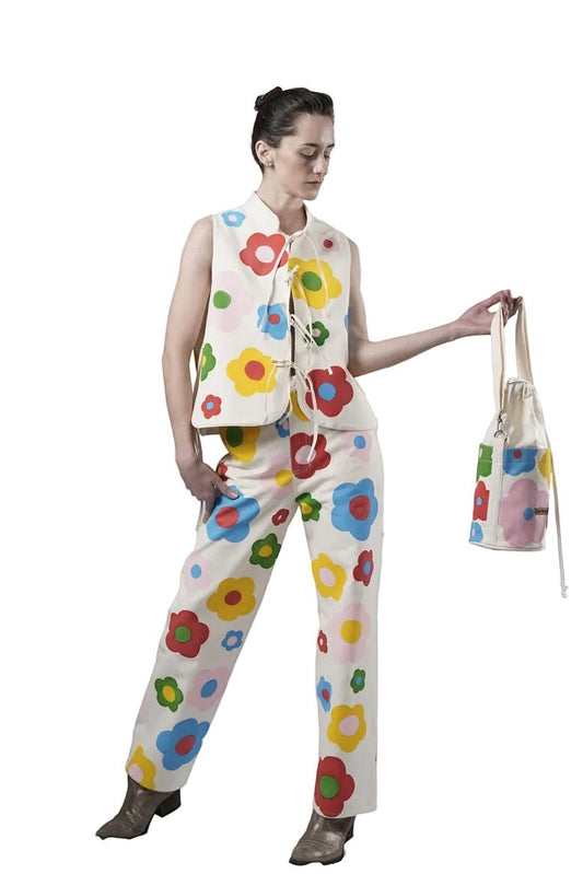 Jose Ibarra Estudio cream canvas vest and pants set with hand-painted colorful flowers. Sleeveless vest with mandarin collar and tie closure.