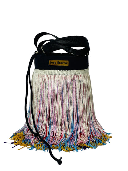 Jose Ibarra Estudio black canvas bucket bag with multicolor fringe detailing and adjustable strap.