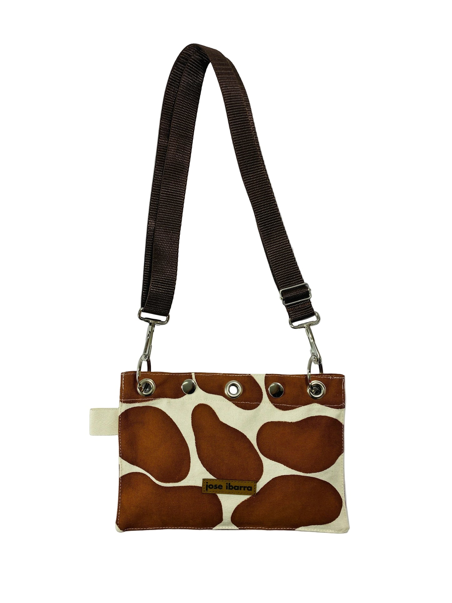 Jose Ibarra Estudio brown and cream giraffe print canvas pouch with adjustable strap and internal lining.