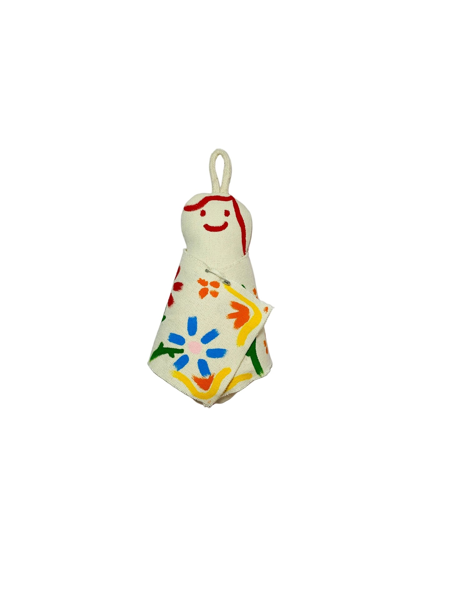 Jose Ibarra Estudio cream cotton keychain with hand-painted abstract floral design and red smiley face.