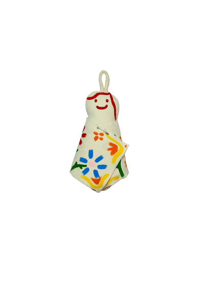 Jose Ibarra Estudio cream cotton keychain with hand-painted abstract floral design and red smiley face.