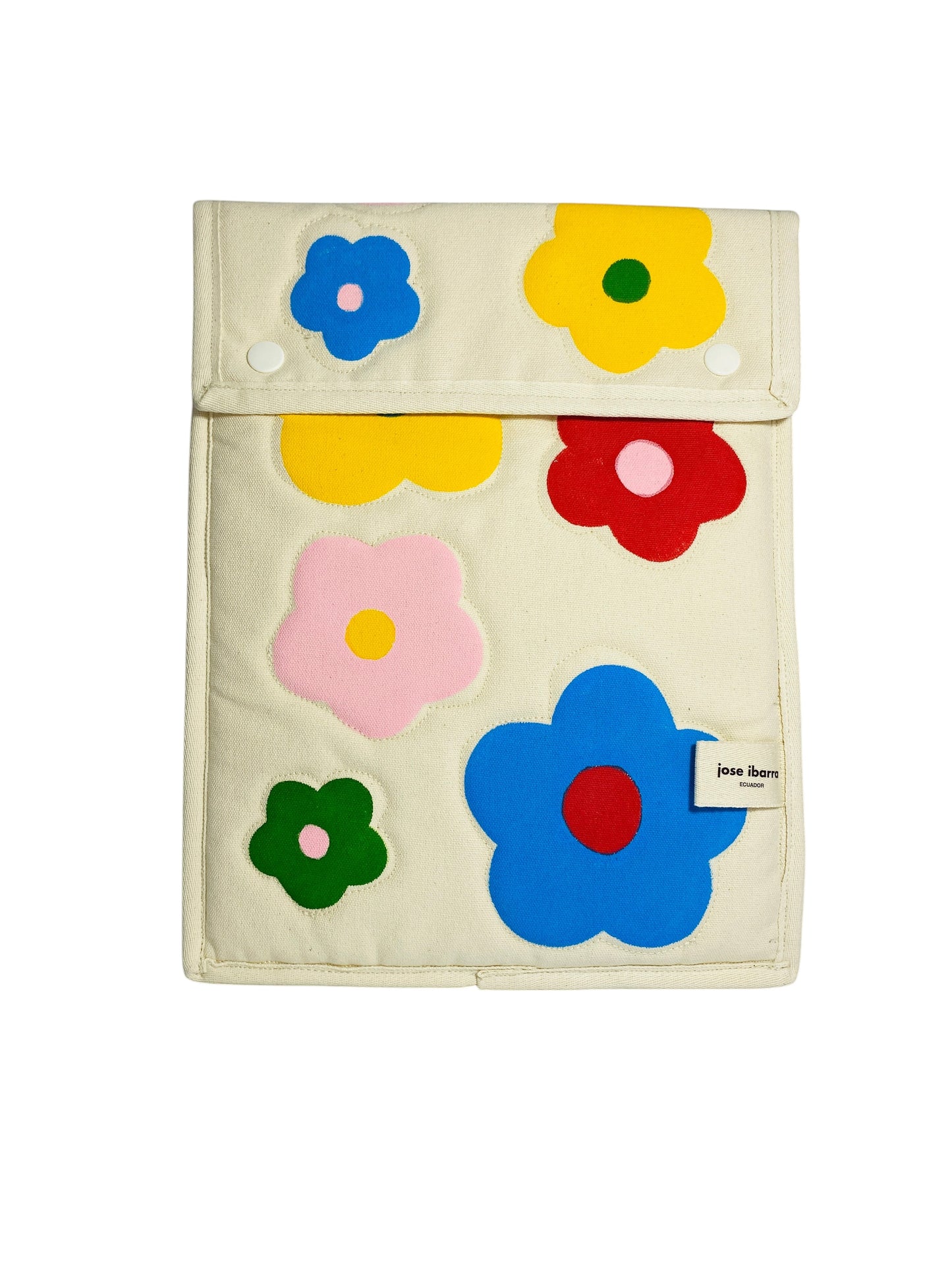 Jose Ibarra Estudio cream cotton iPad sleeve with colorful hand-painted floral appliques in blue, yellow, red, pink, and green.