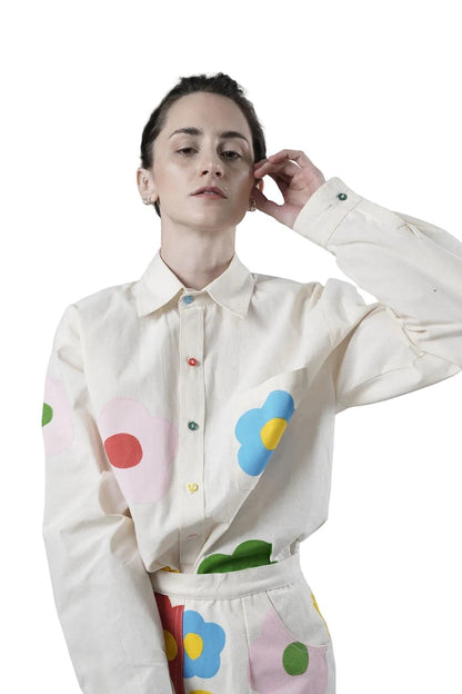 Jose Ibarra Estudio cream 100% cotton loose-fit shirt with hand-painted colourful flower appliques and multi-coloured buttons.