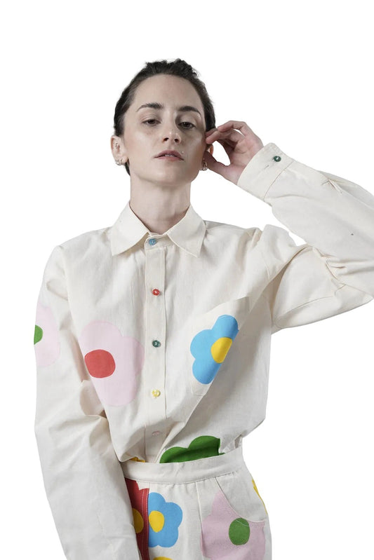 Jose Ibarra Estudio cream 100% cotton loose-fit shirt with hand-painted colourful flower appliques and multi-coloured buttons.