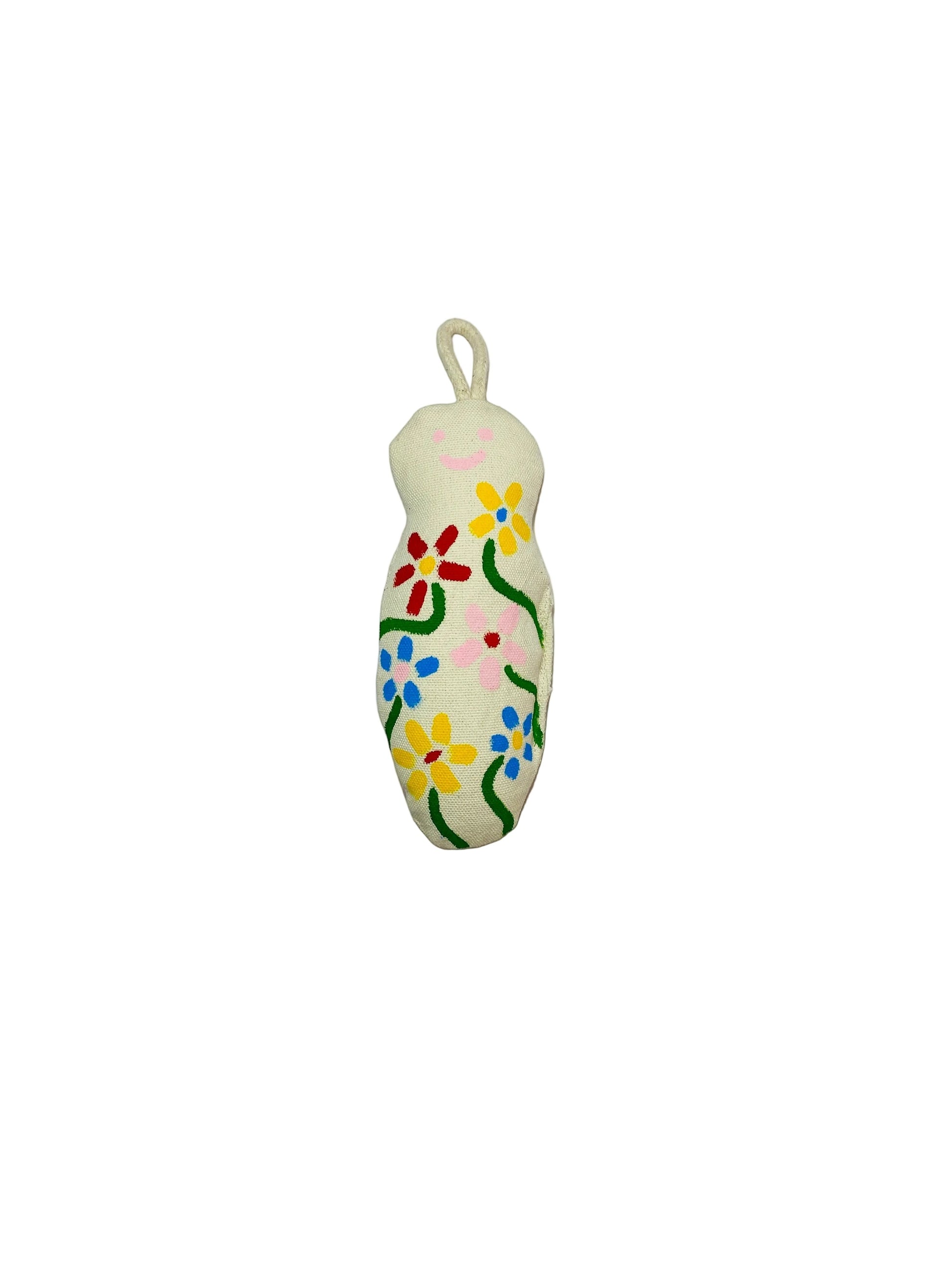 Jose Ibarra Estudio cream cotton keychain with hand-painted flowers and a smiley face.