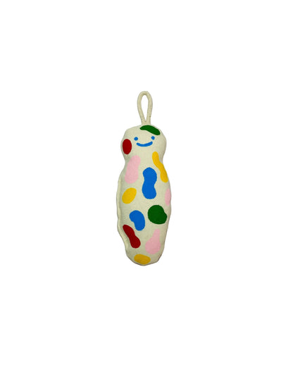 Jose Ibarra Estudio cream cotton keychain with hand-painted colorful abstract shapes and a smiling face.