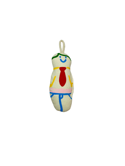 Jose Ibarra Estudio handmade cream cotton keychain with hand-painted smiling face, red tie, and blue overalls design.